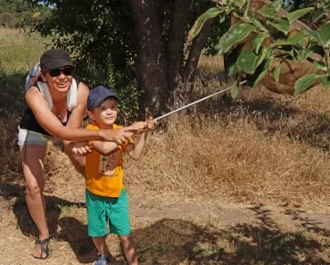 une maman et son fils sont avec un filet à papillons