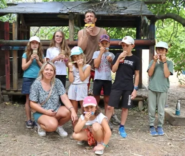 un groupe d'enfants et leurs animateurs jouent de la fûte de pan