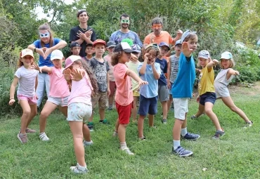 un groupe d'enfants et leurs animateurs déguisés en couleur se mettent en scène avec des poses